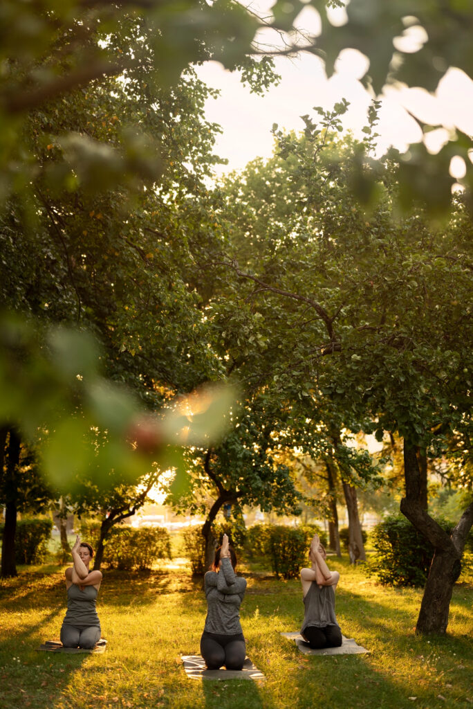 women-meditating-nature-front-view